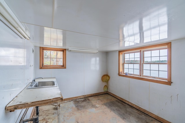below grade area with a sink, healthy amount of natural light, and baseboards