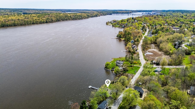 bird's eye view of a nearby body of water and a heavily wooded area