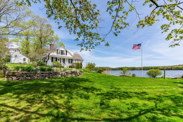 view of grassy yard with a water view