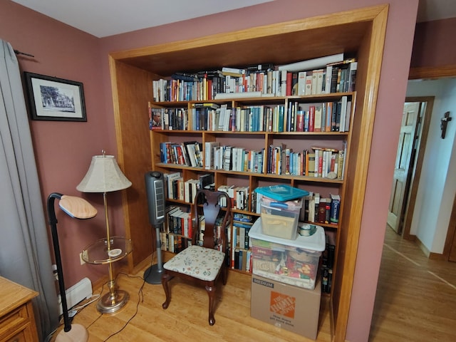 living area with wood finished floors and baseboards