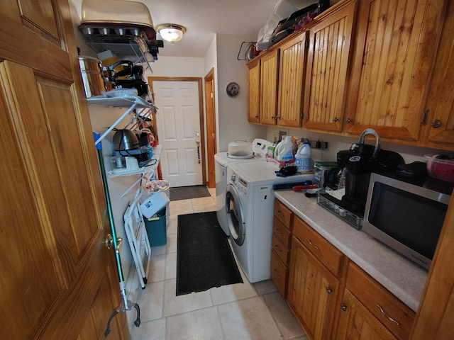 laundry room with light tile patterned flooring and washer and dryer