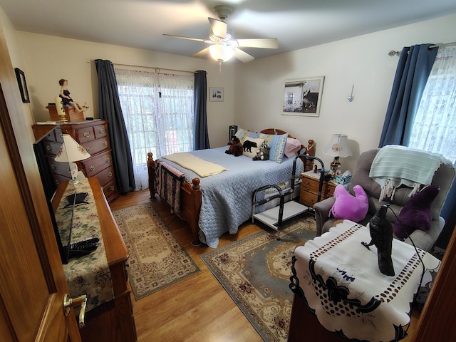 bedroom featuring light wood-style flooring and ceiling fan