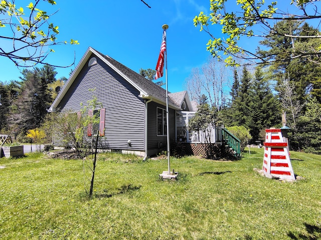 view of side of home featuring a yard