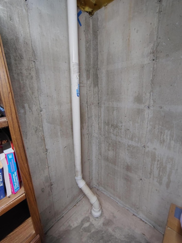 bathroom with unfinished concrete flooring