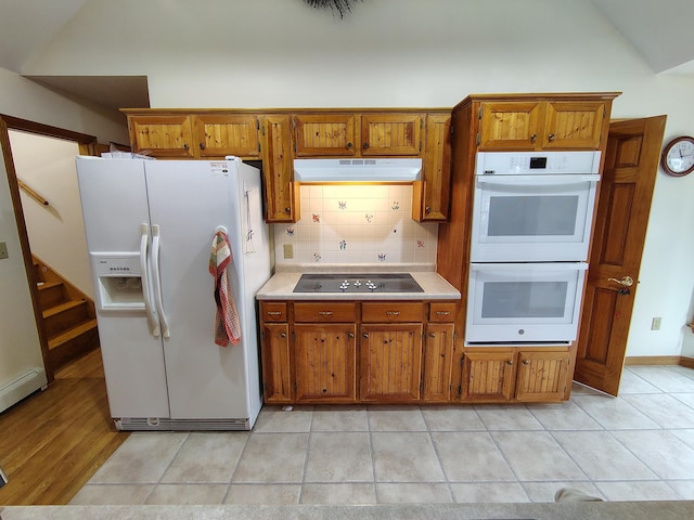 100 Weber Ln, Calais, ME 04619 - kitchen featuring white appliances, under cabinet range hood, brown cabinetry, light countertops, and backsplash