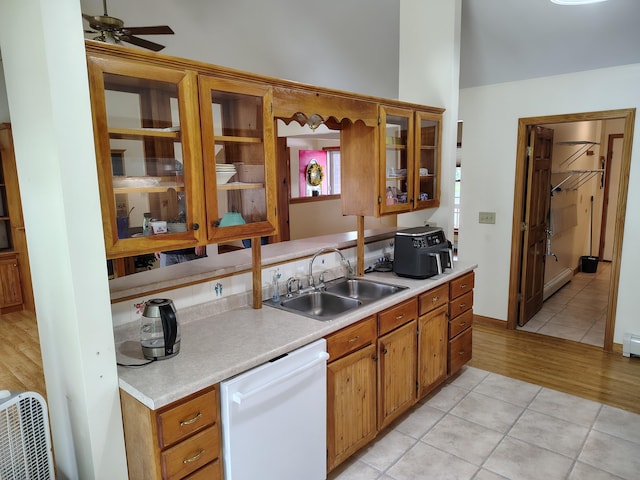 100 Weber Ln, Calais, ME 04619 - kitchen featuring white dishwasher, light countertops, light tile patterned floors, brown cabinets, and vaulted ceiling