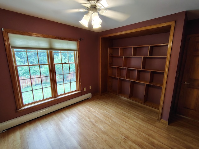 100 Weber Ln, Calais, ME 04619 - unfurnished room featuring a baseboard radiator, light wood finished floors, and a ceiling fan