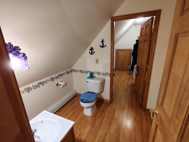 100 Weber Ln, Calais, ME 04619 - half bath featuring wood finished floors, vaulted ceiling, and a baseboard radiator