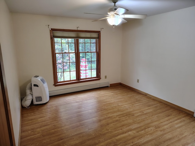 100 Weber Ln, Calais, ME 04619 - spare room featuring a ceiling fan, a baseboard heating unit, and wood finished floors