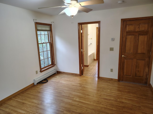 100 Weber Ln, Calais, ME 04619 - empty room featuring a baseboard radiator, light wood-type flooring, and a ceiling fan