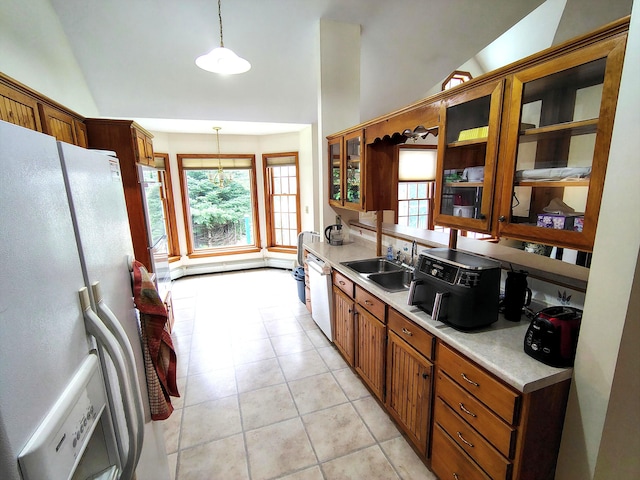 100 Weber Ln, Calais, ME 04619 - kitchen featuring white appliances, light countertops, glass insert cabinets, brown cabinetry, and vaulted ceiling