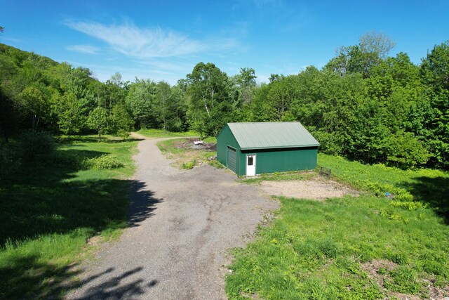 233 Weld Rd, Phillips, ME 04966 - view of outbuilding featuring a forest view