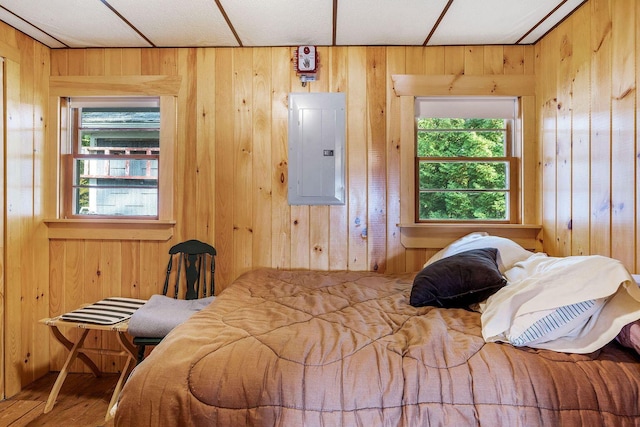 567 Phinney Farm Rd, Lincoln, ME 04457 - bedroom with electric panel, wooden walls, and wood finished floors
