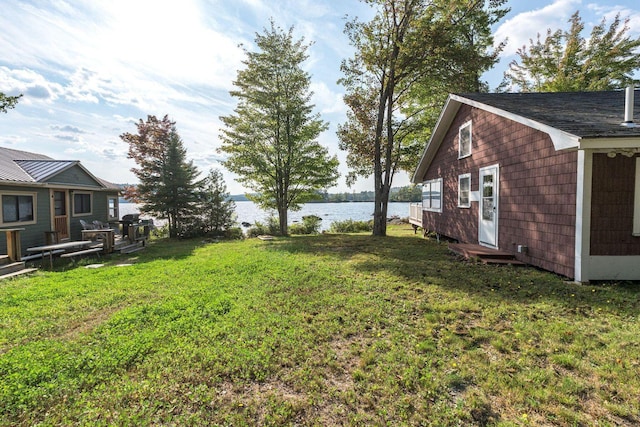 567 Phinney Farm Rd, Lincoln, ME 04457 - view of green lawn with a water view and entry steps