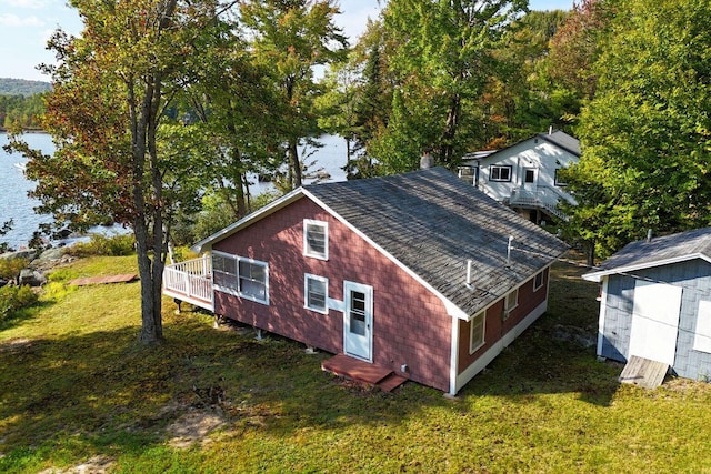 567 Phinney Farm Rd, Lincoln, ME 04457 - view of side of property featuring a water view, roof with shingles, a lawn, and entry steps