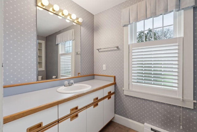 7 Clubhouse Dr, Kennebunk, ME 04043 - bathroom with healthy amount of natural light, wallpapered walls, baseboards, a baseboard radiator, and tile patterned flooring