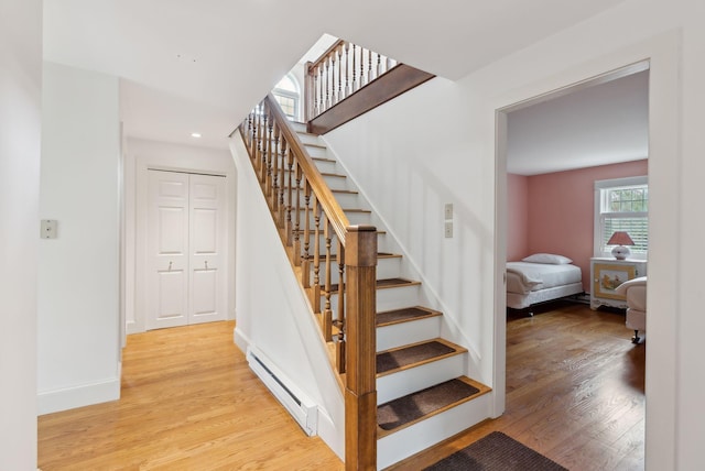 7 Clubhouse Dr, Kennebunk, ME 04043 - stairway with a baseboard radiator, wood finished floors, baseboards, and recessed lighting