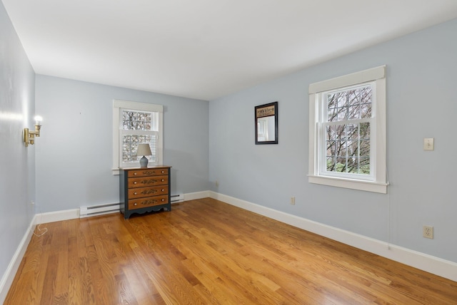 7 Clubhouse Dr, Kennebunk, ME 04043 - spare room featuring healthy amount of natural light, light wood-style flooring, baseboards, and a baseboard radiator