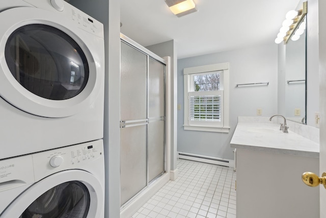 7 Clubhouse Dr, Kennebunk, ME 04043 - laundry area with stacked washer / drying machine, light tile patterned floors, a baseboard radiator, and baseboards