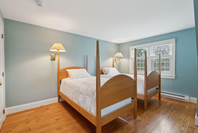 7 Clubhouse Dr, Kennebunk, ME 04043 - bedroom featuring a baseboard heating unit, baseboards, and light wood-type flooring