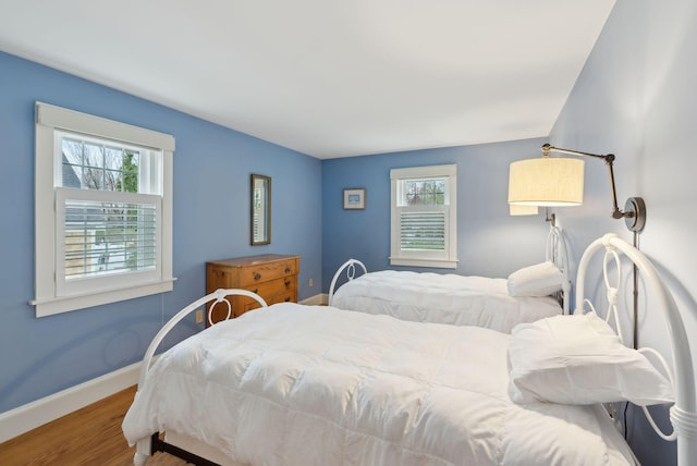 7 Clubhouse Dr, Kennebunk, ME 04043 - bedroom featuring multiple windows, baseboards, and wood finished floors
