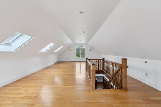 7 Clubhouse Dr, Kennebunk, ME 04043 - bonus room with lofted ceiling, a skylight, light wood finished floors, a baseboard radiator, and baseboards