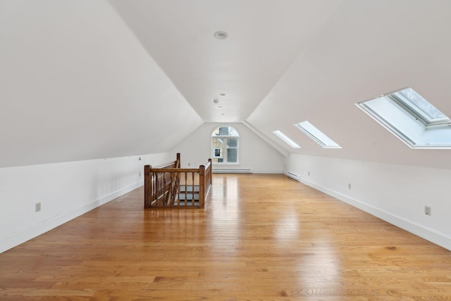 7 Clubhouse Dr, Kennebunk, ME 04043 - bonus room with a skylight, vaulted ceiling, a baseboard radiator, light wood finished floors, and a baseboard heating unit
