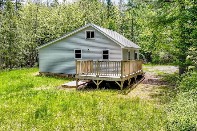 204 Weymouth Rd, Morrill, ME 04952 - rear view of house with a wooden deck and a forest view