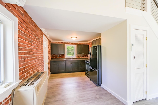 204 Weymouth Rd, Morrill, ME 04952 - kitchen with black appliances, a sink, brick wall, light wood-style flooring, and baseboards