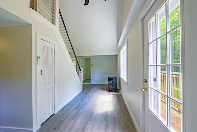 204 Weymouth Rd, Morrill, ME 04952 - foyer entrance with a wood stove, wood finished floors, stairway, and baseboards