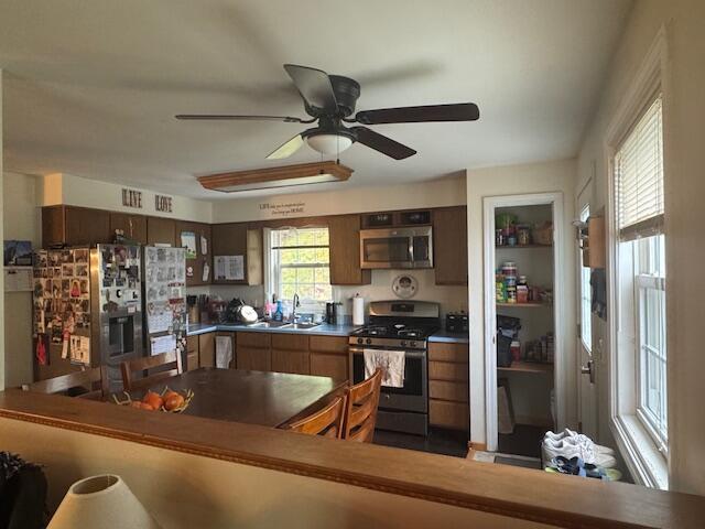 20 Oak Ridge Dr, Chelsea, ME 04330 - kitchen featuring stainless steel appliances, a sink, a ceiling fan, and dark countertops