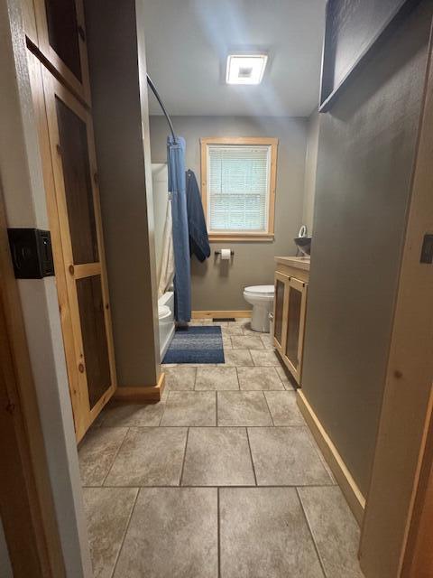 20 Oak Ridge Dr, Chelsea, ME 04330 - full bath featuring toilet, vanity, baseboards, and tile patterned floors