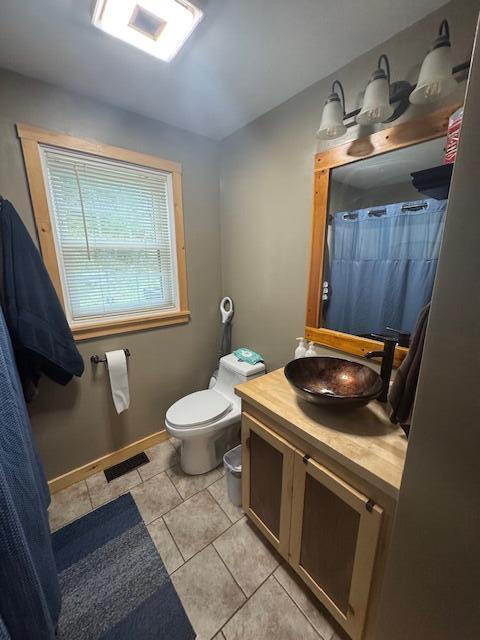 20 Oak Ridge Dr, Chelsea, ME 04330 - full bath featuring vanity, toilet, tile patterned flooring, and curtained shower