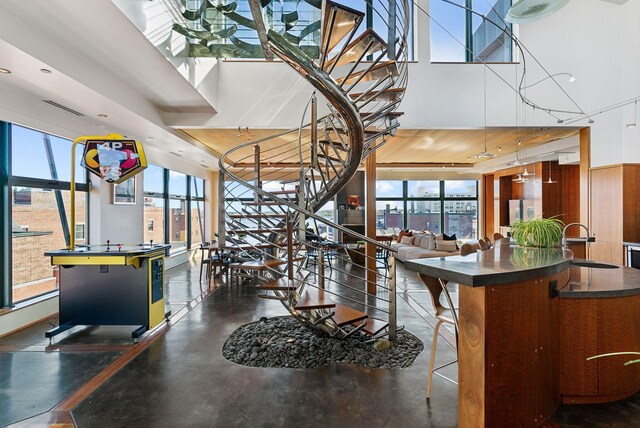 547 Congress St Unit 6, Portland, ME 04101 - dining area featuring a towering ceiling, stairway, and concrete floors