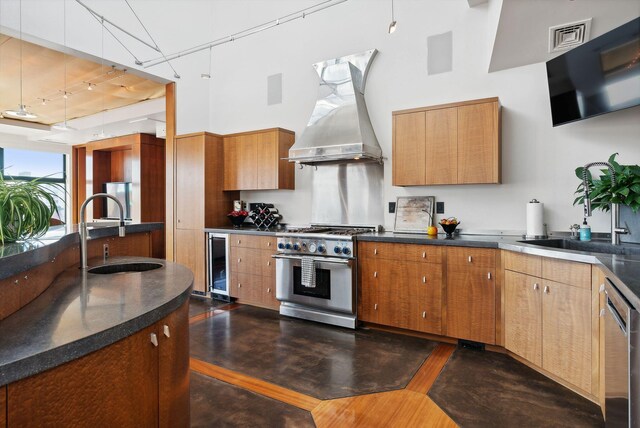547 Congress St Unit 6, Portland, ME 04101 - kitchen featuring appliances with stainless steel finishes, a sink, exhaust hood, a towering ceiling, and beverage cooler
