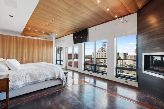 547 Congress St Unit 6, Portland, ME 04101 - bedroom featuring access to exterior, concrete floors, rail lighting, and wood ceiling