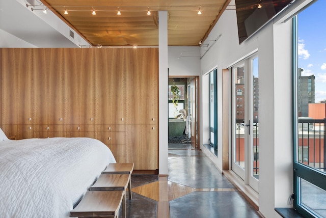 547 Congress St Unit 6, Portland, ME 04101 - bedroom with access to outside, wood finished floors, and rail lighting