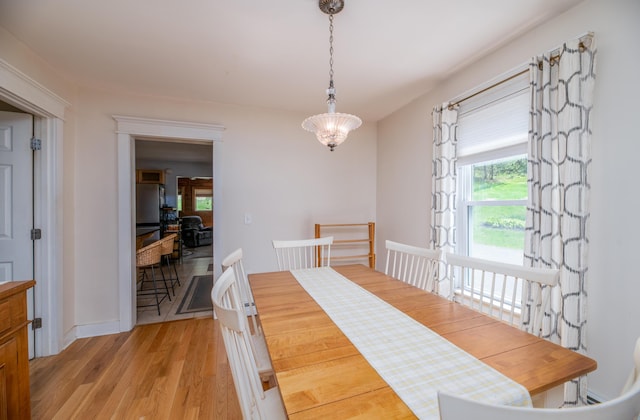 626 Wiscasset Rd, Pittston, ME 04345 - dining space featuring light wood-style floors, a chandelier, and baseboards