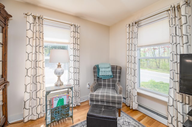 626 Wiscasset Rd, Pittston, ME 04345 - sitting room featuring wood finished floors and a baseboard heating unit