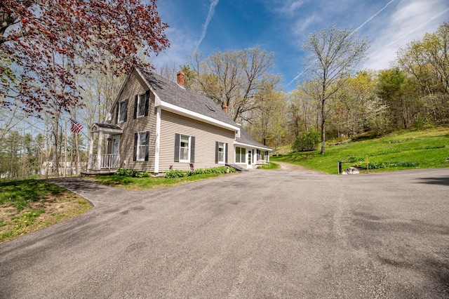 626 Wiscasset Rd, Pittston, ME 04345 - view of side of home featuring a chimney, driveway, and a shingled roof