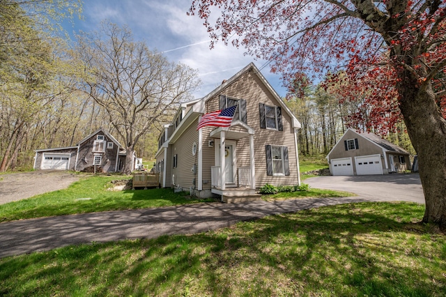 626 Wiscasset Rd, Pittston, ME 04345 - view of front of house featuring an outdoor structure, a detached garage, and a front yard