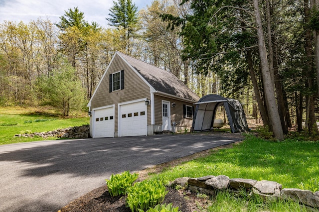 626 Wiscasset Rd, Pittston, ME 04345 - view of side of property with an outdoor structure, a garage, a shingled roof, and driveway