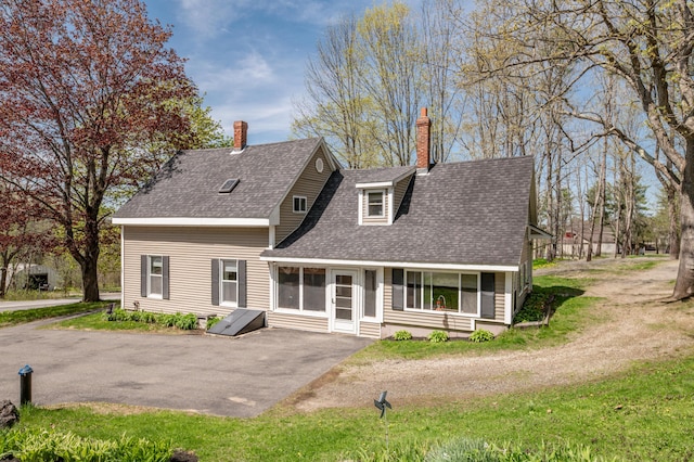 626 Wiscasset Rd, Pittston, ME 04345 - view of front of property with a shingled roof, a chimney, a patio area, and asphalt driveway
