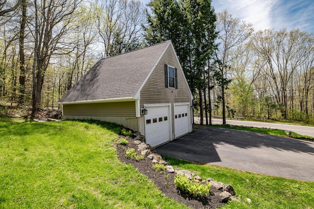 626 Wiscasset Rd, Pittston, ME 04345 - view of side of home featuring a yard, asphalt driveway, a shingled roof, and an attached garage