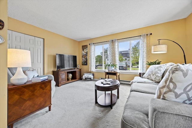 18 Ocean St Unit 72, South Portland, ME 04106 - carpeted living area with a textured ceiling and a baseboard heating unit