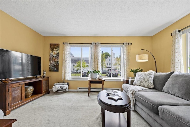 18 Ocean St Unit 72, South Portland, ME 04106 - living area featuring a baseboard radiator, carpet floors, a textured ceiling, and baseboards