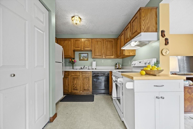 18 Ocean St Unit 72, South Portland, ME 04106 - kitchen featuring white appliances, under cabinet range hood, light countertops, brown cabinetry, and light flooring