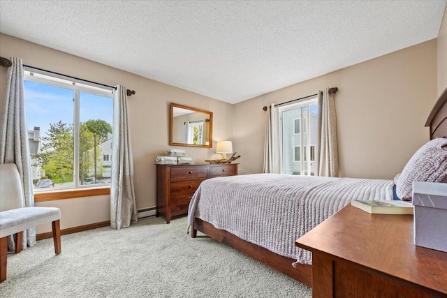 18 Ocean St Unit 72, South Portland, ME 04106 - bedroom with light colored carpet, a textured ceiling, baseboards, and a baseboard heating unit