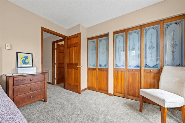 18 Ocean St Unit 72, South Portland, ME 04106 - bedroom featuring light colored carpet, two closets, a textured ceiling, and baseboards