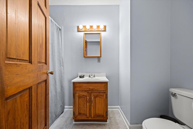 18 Ocean St Unit 72, South Portland, ME 04106 - bathroom with vanity, toilet, tile patterned flooring, and baseboards